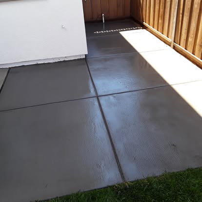 A finished poured-concrete patio beside the house.